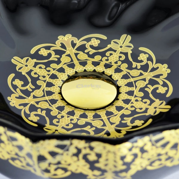 cuba de cerâmica preta com detalhes dourados